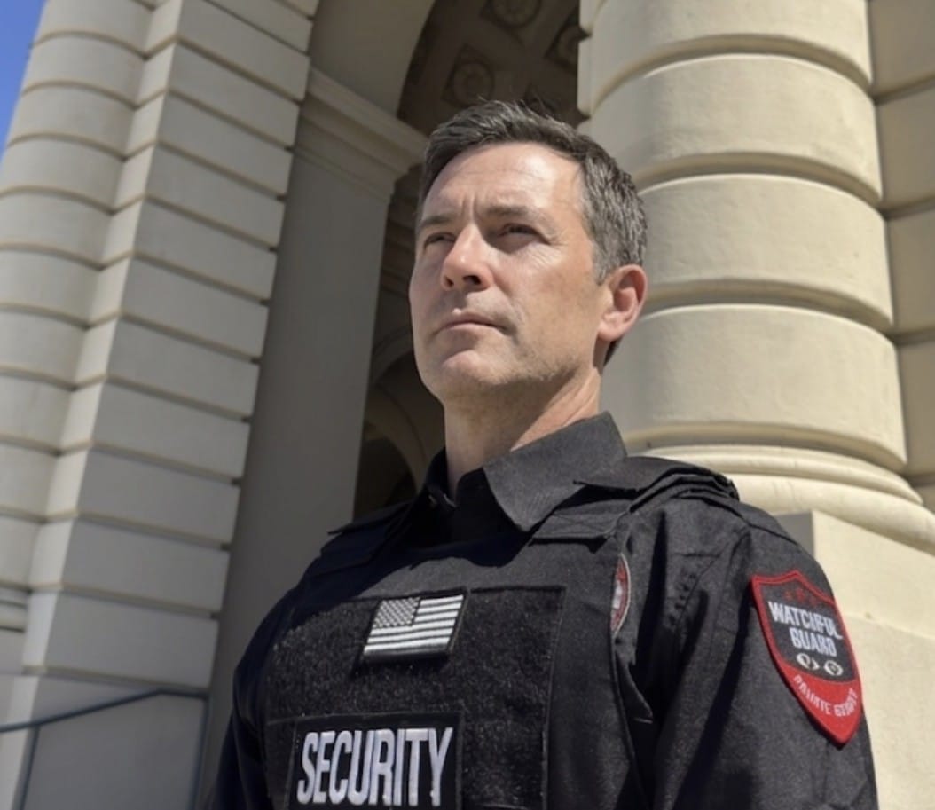 BSIS licensed commercial security guard at a building lobby entrance